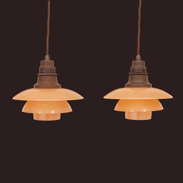 Pair of Poul Henningsen PH2/2 pendants with salmon coloured glass shades. 
Denmark 1930s. D: 20cm