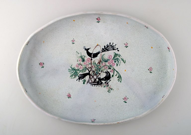 Bjørn Wiinblad: Rare and early unique large oval platter decorated with flower 
basket and peacocks, Bjørn Wiinblad approx. 1945-50.