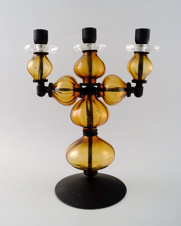 Erik Höglund for Kosta Boda, large three-armed candlestick of cast iron with 
hand-blown art glass.