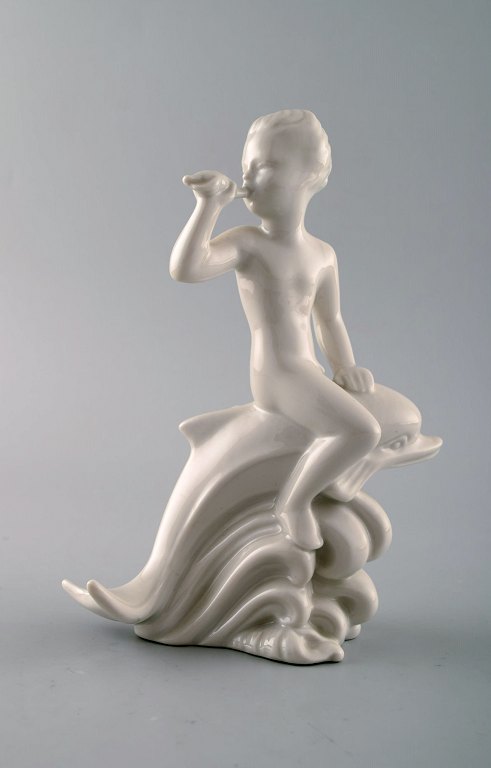 Harald Salomon for Rörstrand, blanc de chine / white glazed figure of a fawn 
riding on delphin.