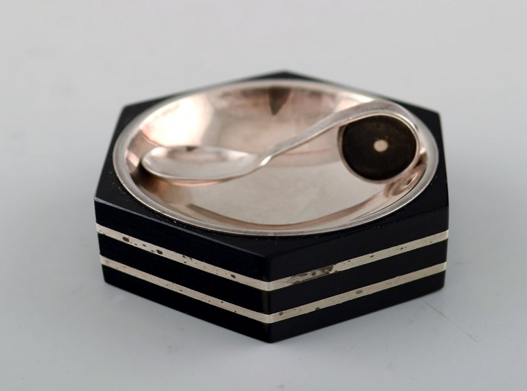 GAB (Guldsmedsaktiebolaget) art deco hexagonal salt cellar in silver and ebony 
with matching salt spoon.