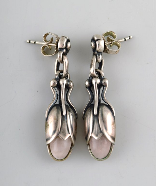 A pair of earrings in sterling silver by Georg Jensen adorned with rose quartz.