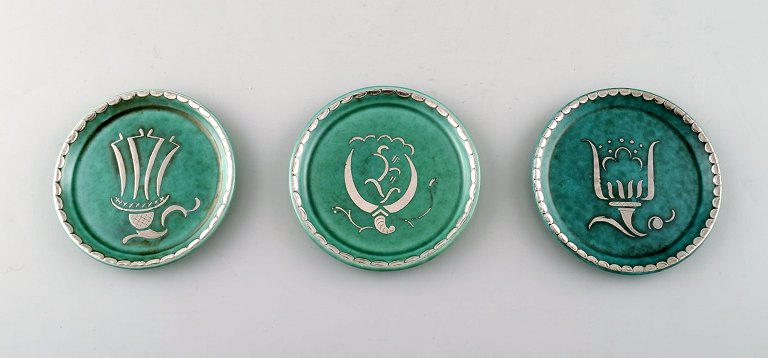 Wilhelm Kåge, Gustavsberg, set of 3 coasters decorated with silver inlaid.