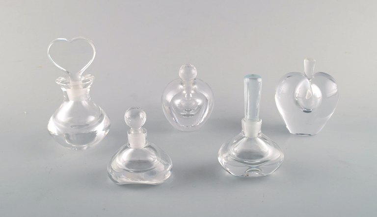 Edward Hald for Orrefors, Sweden. A collection of five mouth blown flacons in 
clear art glass. Designed in the 1940