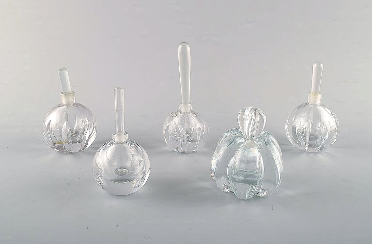 Edward Hald for Orrefors. A collection of five mouth blown flacons in clear art 
glass. Designed in the 1940