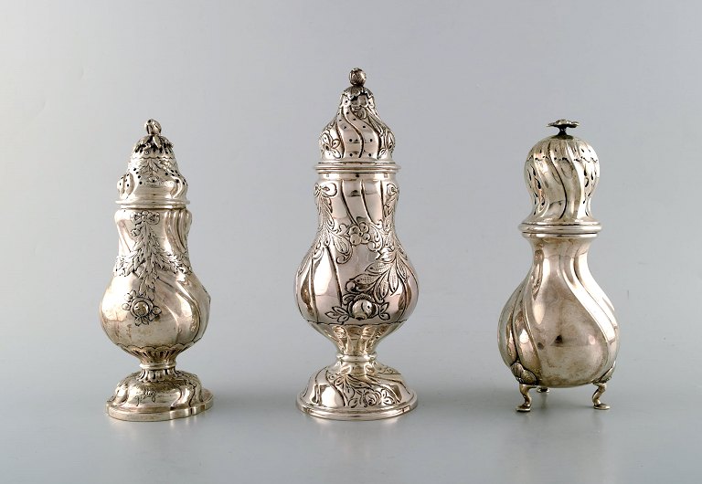 Hugo Grün a.o. Three Danish neo rococo sugar castors in silver (830). 1950