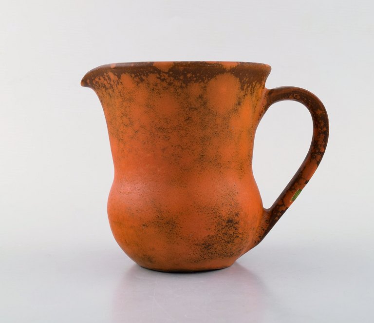 Kähler, Denmark. Jug in glazed stoneware. Beautiful orange uranium glaze. 1930 / 
40