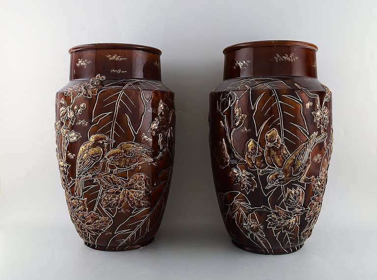 A pair of large Longchamp majolica vases in reddish brown glaze. Birds and 
leaves in gold. 1920