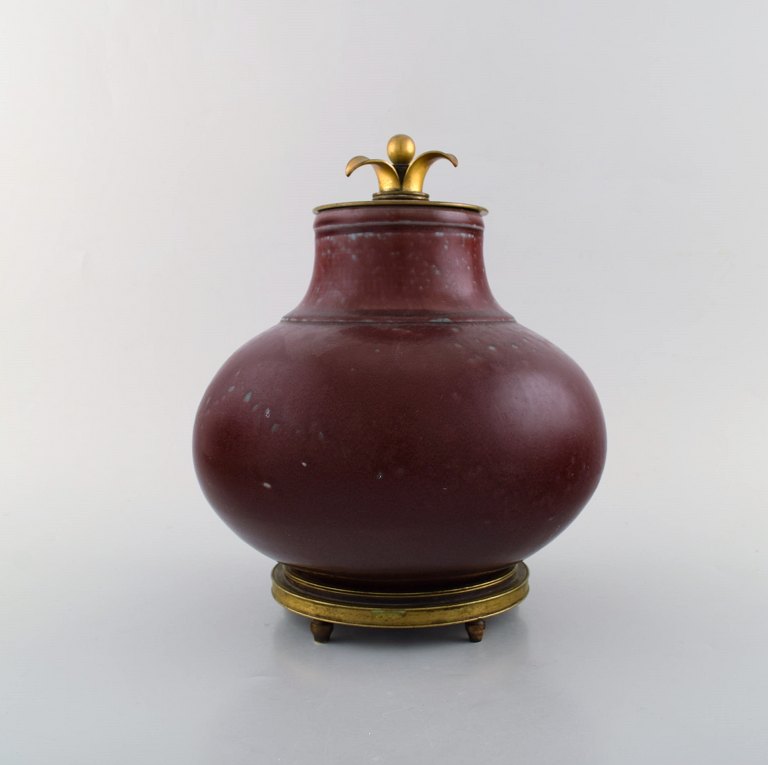 Patrick Nordstrøm / Carl Halier for Royal Copenhagen, lidded vase of stoneware 
with bronze foot and bronze lid by Knud Andersen. Dated 1919. Beautiful ox blood 
glaze.
