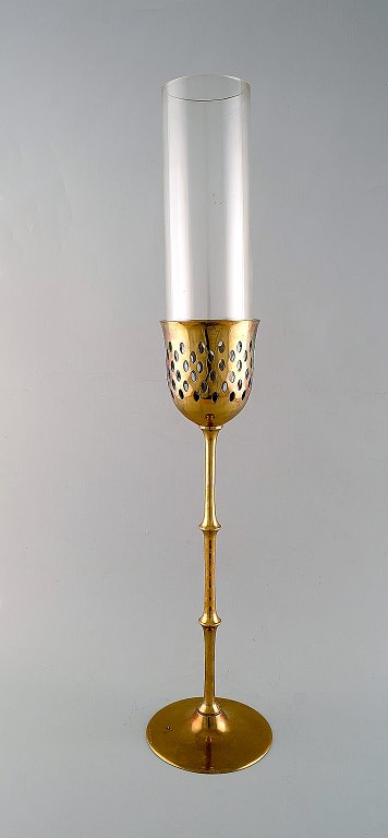 Bjørn Wiinblad (1918-2006). Tall "Hurricane" candle holder in brass with blue 
tinted glass. 1970