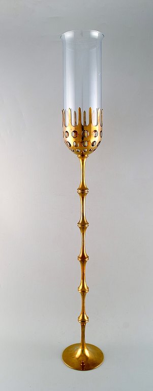 Bjørn Wiinblad (1918-2006). Very tall "Hurricane" candle holder in brass with 
blue tinted glass. 1970