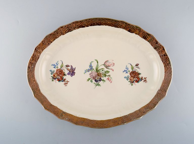 Royal Copenhagen serving dish in porcelain with floral motifs and gold border. 
Mid 20th century.
