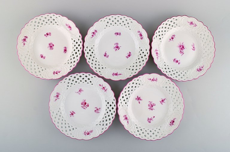 Fem antikke gennembrudte Meissen tallerkener i håndmalet porcelæn med lyserøde 
blomstermotiver. 1800-tallet.
