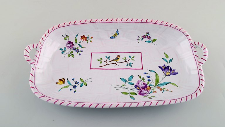 Emile Gallé for St. Clement, Nancy. Dish on four feet in hand-painted faience. 
Decorated with flowers and birds. 1870