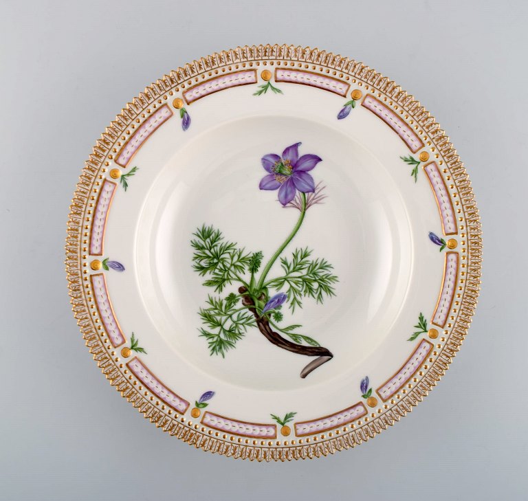 Royal Copenhagen flora danica deep plate in porcelain with hand-painted flowers 
and gold decoration.
