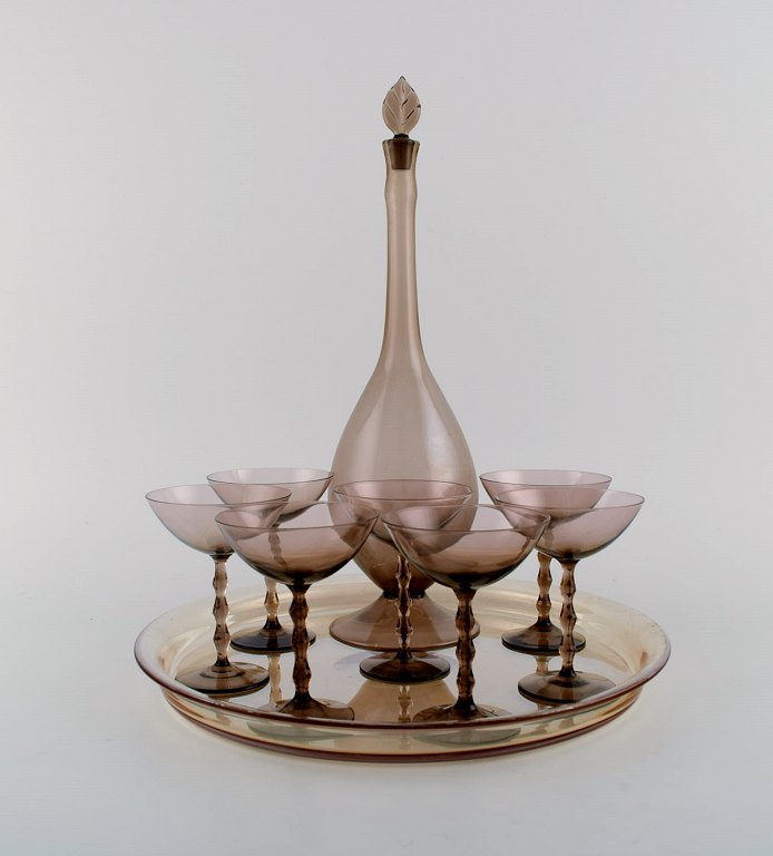 Simon Gate for Orrefors. Art deco liqueur set in smoky mouth-blown art glass. 
Seven glasses, carafe and tray. 1930