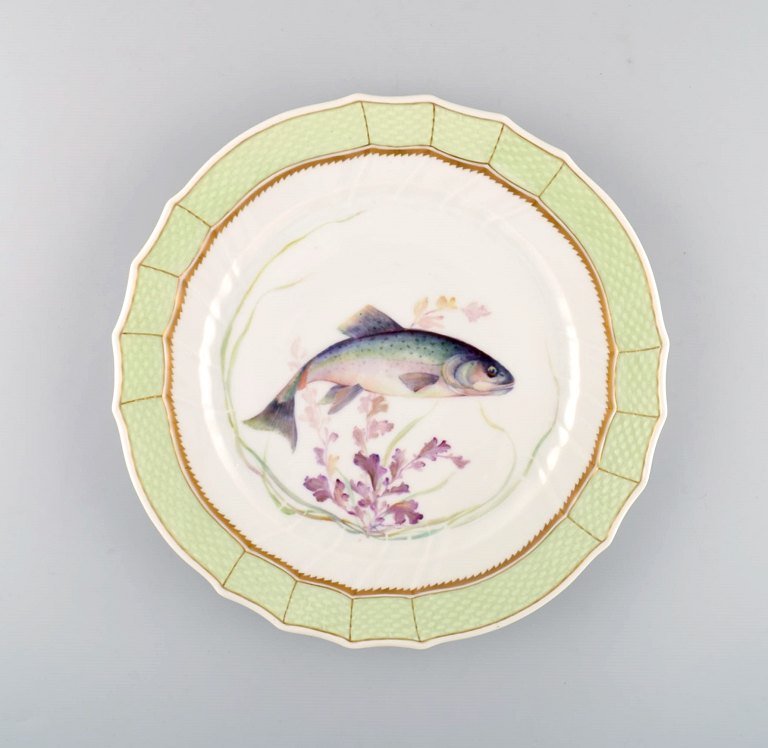 Royal Copenhagen fish plate with green edge, gold decoration and fish motif. 
Model 919/1710.
