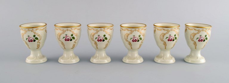 Six Rosenthal Classic Rose egg cups in hand-painted porcelain with flowers and 
gold decoration. Mid-20th century.
