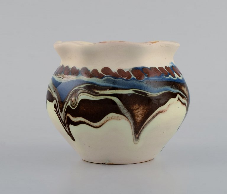 Kähler, Denmark. Glazed stoneware vase in modern design. Blue and brown running 
glaze on a cream background. 1930s / 40s.
