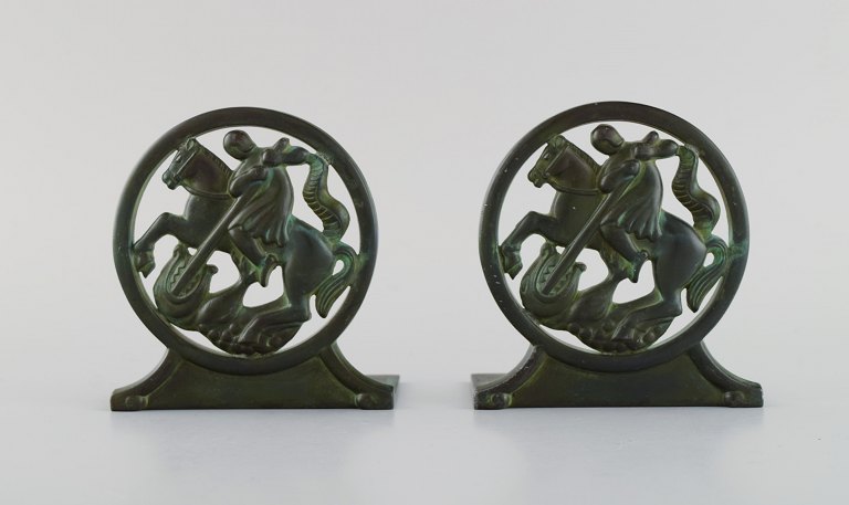 Just Andersen, Denmark. A pair of art deco bookends in disko metal with Saint 
George and the dragon. 1940s. Model number 1626.
