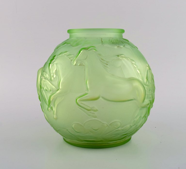 Edvin Ollers (1888-1959) for Elme. Round art deco vase in green frosted pressed 
art glass with galloping horses. Swedish design, 1930s.
