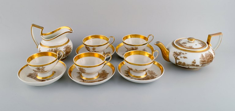 Antique Empire tea service for five people in porcelain with hand-painted 
village motifs and gold edge. Dated 1831.
