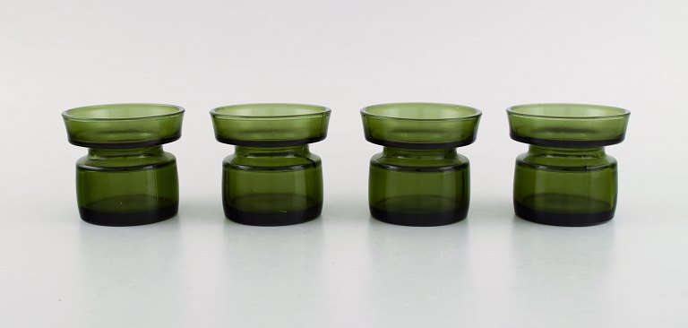 Jens Harald Quistgaard. Four "Hygge" light holders for teacandles in dark green 
art glass. Retro, 1960