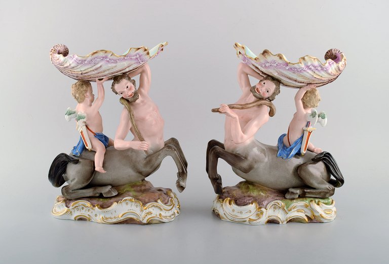 A pair of antique figurative Meissen compotes in hand-painted porcelain. Puti on 
centaur carrying large seashell. Museum quality. Dated 1815-1860.
