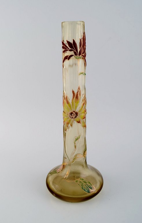 Large antique Emile Gallé Japanism vase in clear frosted art glass. Carved with 
motifs in the form of flowers and leaves in yellow and red. Museum quality, 
1890