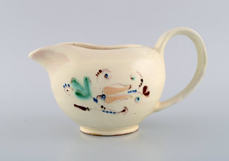 Kähler, Denmark. Jug in glazed ceramics. Flowers on cream colored background. 
Modern design, 1930s / 40s.
