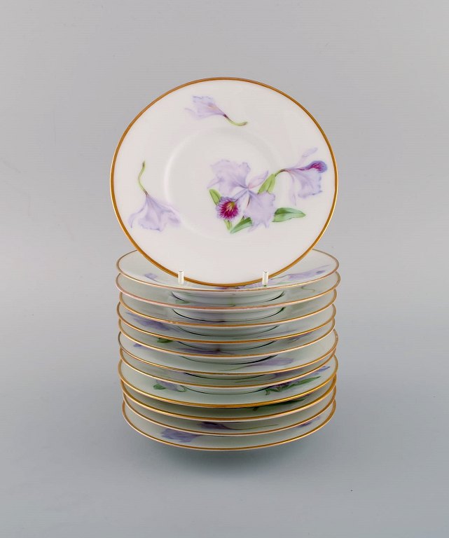 Twelve antique unique Royal Copenhagen porcelain plates with hand-painted purple 
lotus flowers. Model number 72/10522. Approx. 1910.
