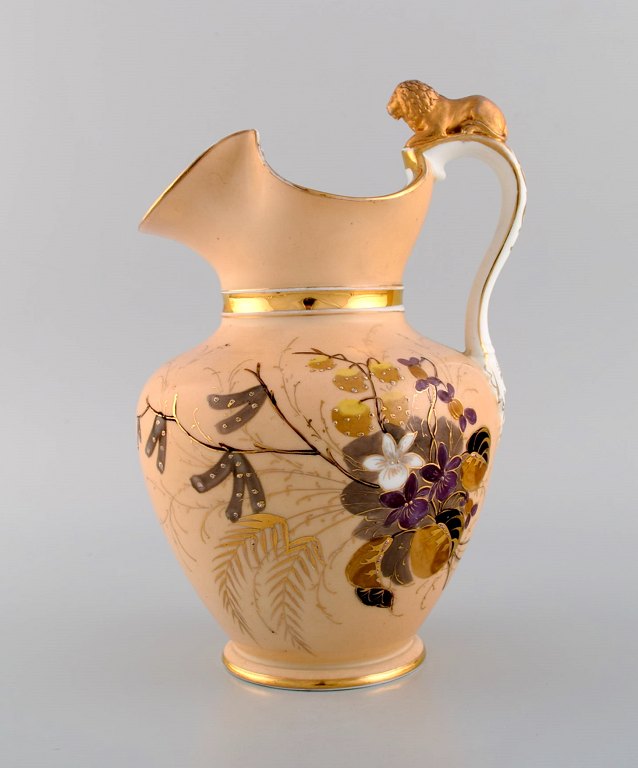 Antique Altwasser chocolate jug in porcelain modeled with a lion on the handle. 
Hand-painted flowers and gold decoration. Late 19th century.
