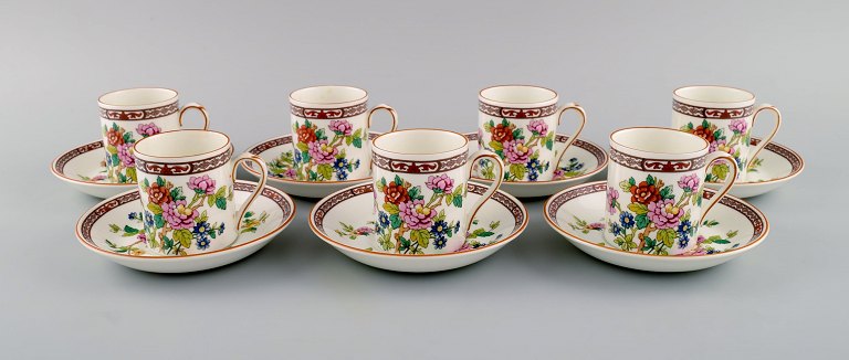 Coalport, England. Seven Flower of Tibet chocolate cups with saucers decorated 
with flowers and gold edge. Mid-20th century.
