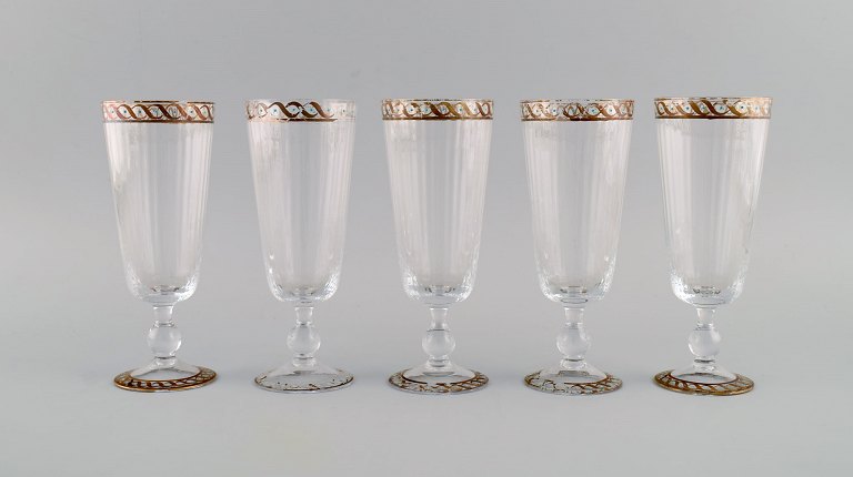 Nason & Moretti, Murano. Five wine glasses in mouth-blown art glass with 
hand-painted turquoise and gold decoration. 1930s.

