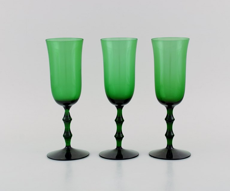 Simon Gate for Orrefors. Three Salut champagne glasses in green mouth blown art 
glass. Swedish design, 1920s / 30s.
