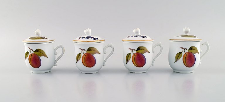 Royal Worcester, England. Four Evesham porcelain cream cups decorated with 
fruits and gold edge. 1960s.
