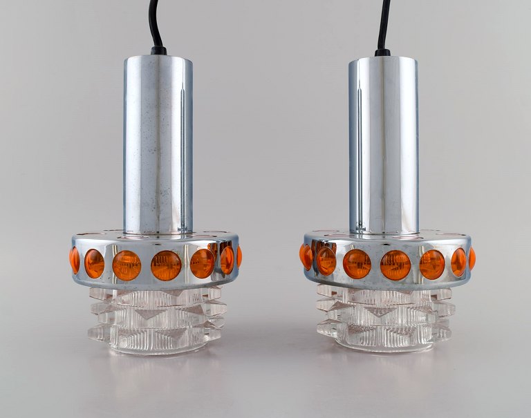 Raak, Holland. Two ceiling pendants in chromed metal and art glass. 1970s.
