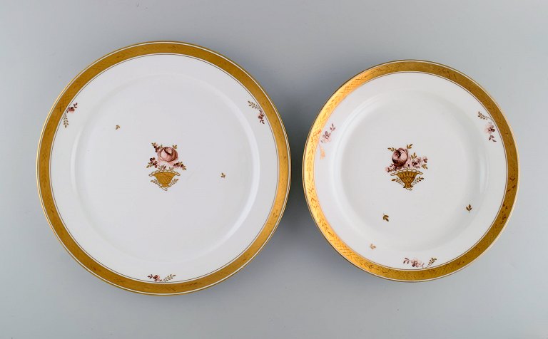 Two round Royal Copenhagen Golden Basket serving dishes in porcelain with 
flowers and gold decoration. Early 20th century.
