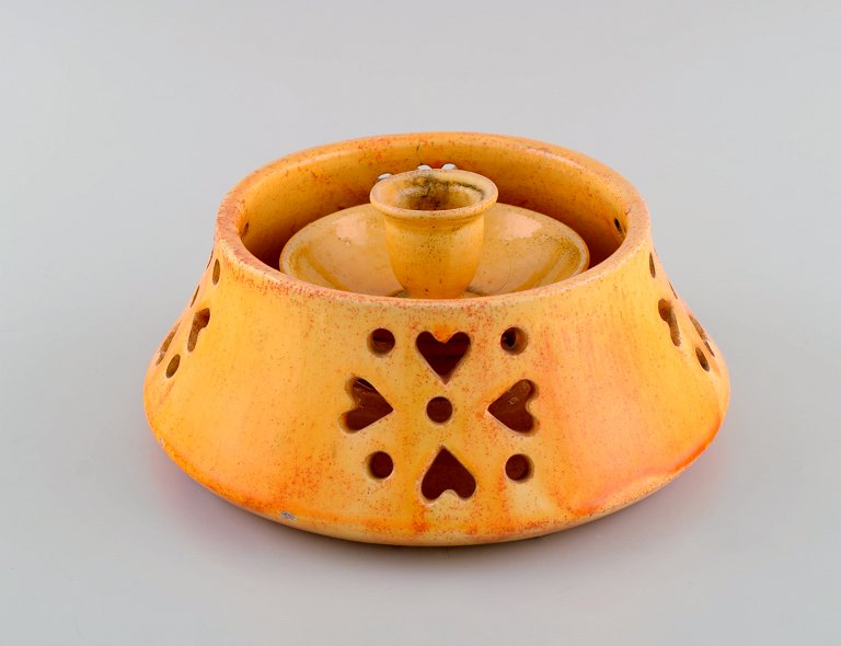 Kähler, Denmark. Candlestick with heater in glazed stoneware. Beautiful orange 
uranium glaze. Mid-20th century.
