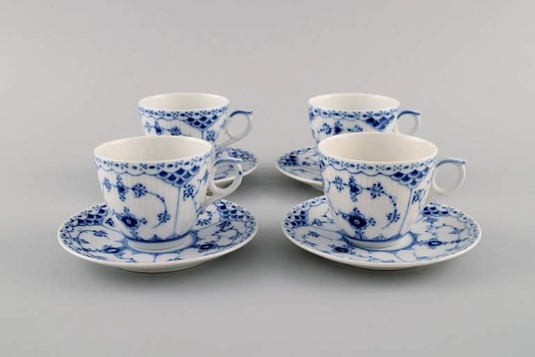 Four Royal Copenhagen Blue Fluted Half Lace coffee cups with saucers. Model 
number 1/528.
