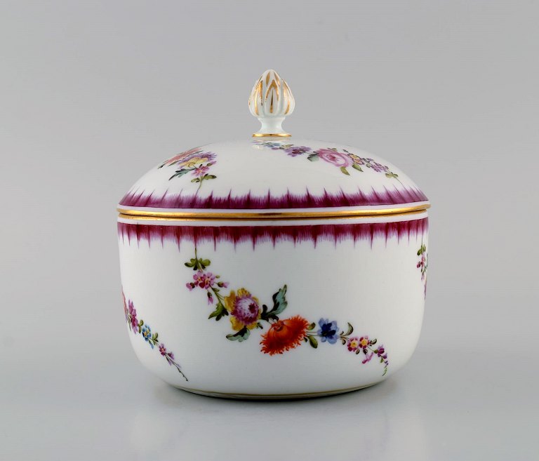 Antique Meissen porcelain lidedd bowl with hand-painted flowers and gold edge. 
Lid knob modeled as a rose bud. Late 19th century.
