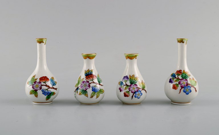 Four Herend porcelain vases with hand-painted flowers and butterflies. Mid-20th 
century.
