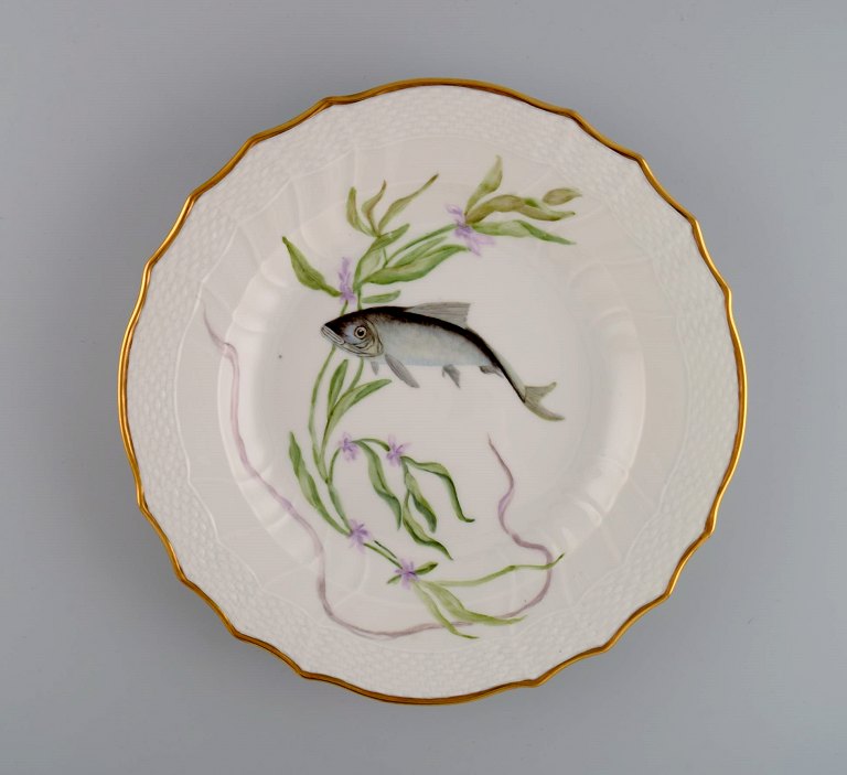 Royal Copenhagen porcelain dinner plate with hand-painted fish motif and golden 
border. Flora / Fauna Danica style. Dated 1968.
