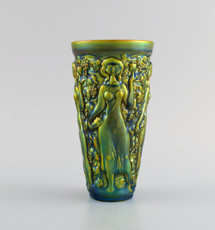 Zsolnay vase in glazed ceramics modeled with women picking grapes. Beautiful 
luster glasses. Mid-20th century.
