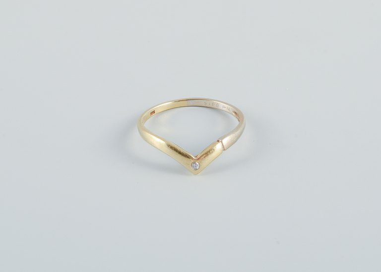 Scandinavian goldsmith. Modernist gold ring adorned with brilliant.
Stamped with the goldsmith