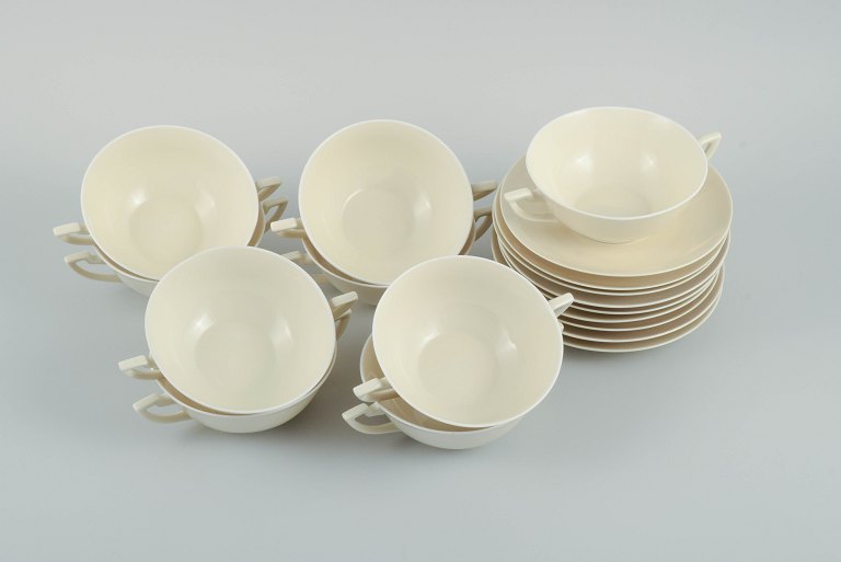 Nine pairs of Royal Copenhagen cream-coloured bouillon cups with matching 
saucers.