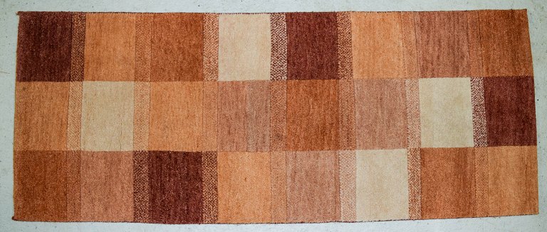 Milford, Sweden, pure wool rug. Geometric fields in red, orange and white 
shades.