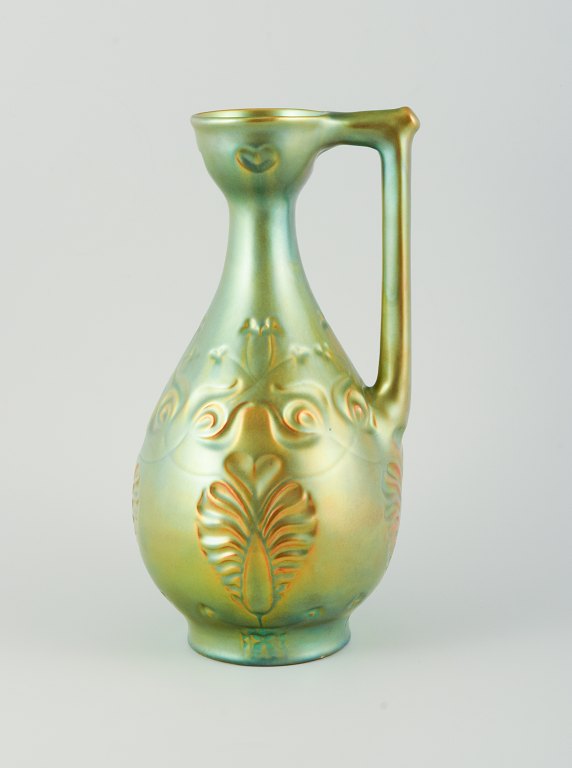 Zsolnay, Hungary. Large ceramic jug with eosin glaze modeled with foliage.