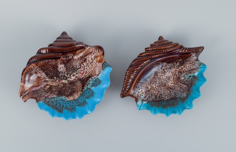 Vallauris, France, two snail-shaped bowls glaze in shades of brown and blue.