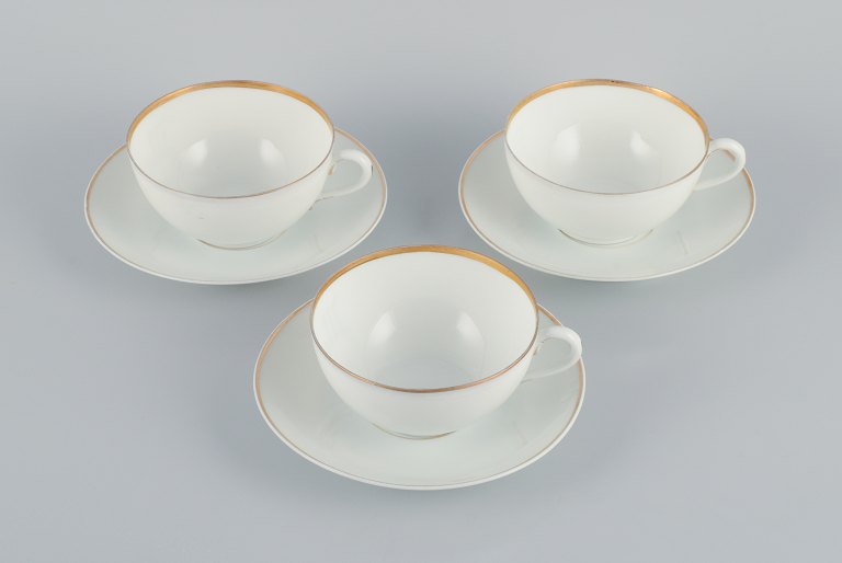 Rosenthal, Germany, a set of three large teacups and matching porcelain saucers. 
Thin white porcelain with gold decoration.